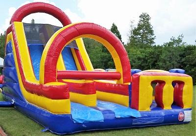 Inflatable obstacle course with slide